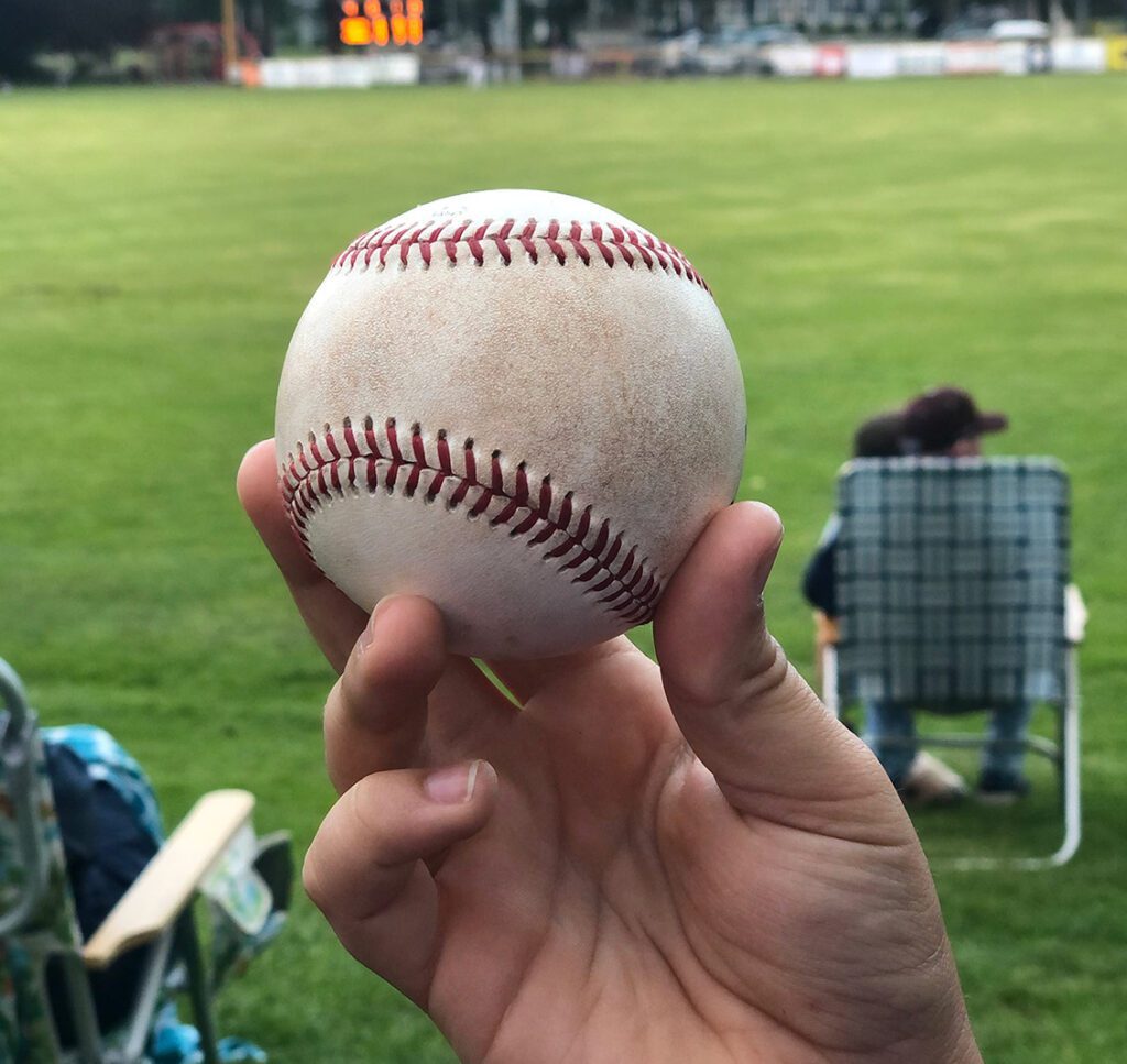 My son proudly holding up a foul ball he snagged at a Firebirds game.